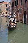 Tourists ride in a gondola in Venice, Italy