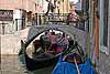 A gondola passes under a bridge in Venice, Italy