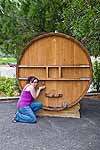Lisa tries to get wine from a vat on display at a winery in La Croix-Valmer