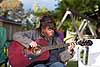 Dee playing guitar at her cottage