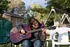 Dee playing guitar at her cottage